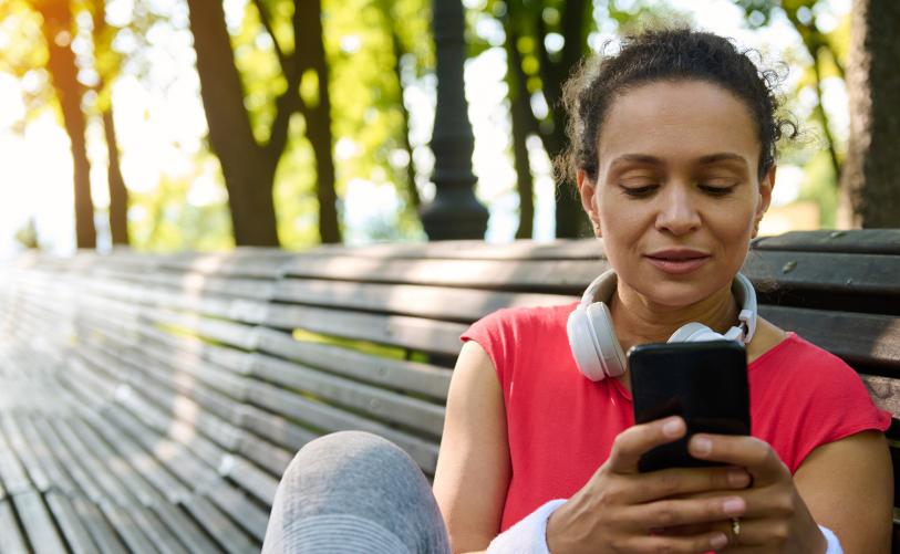 About PN header image, woman looking at health app on phone
